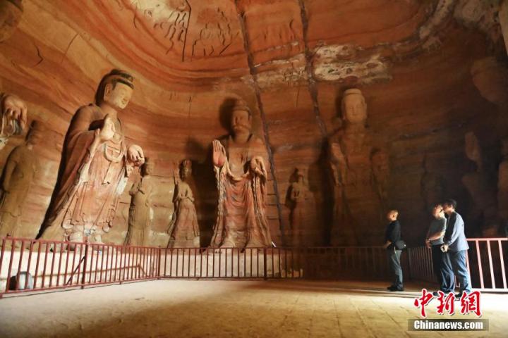 7月15日，游人參觀甘肅省平?jīng)鍪袥艽h百里石窟長廊中的南石窟寺1號窟。百里石窟長廊位于涇川縣境內(nèi)，由512個石窟、5眼窟中石井組成，現(xiàn)存王母宮石窟、鳳凰山石窟、南石窟寺、丈八寺石窟、羅漢洞石窟、太山寺石窟等規(guī)模較大的石窟群，還有數(shù)量眾多的小石窟群。南石窟寺開鑿于北魏永平三年，其中1號窟屬于大型七佛窟，七佛高達6米。中新社記者 李亞龍 攝